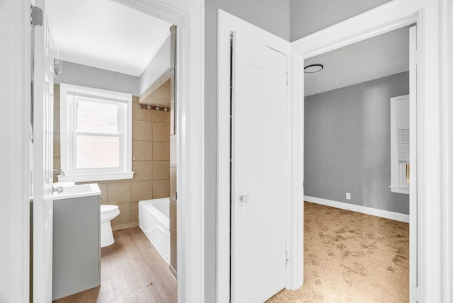 full bathroom with vanity, tiled shower / bath, and toilet