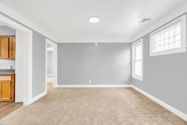 unfurnished living room featuring crown molding and light carpet