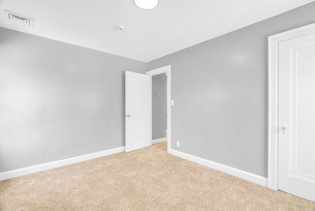 unfurnished bedroom featuring light carpet