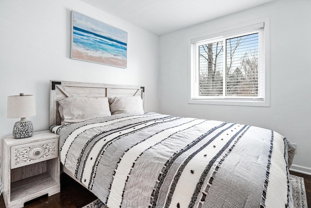 bedroom with dark wood-type flooring