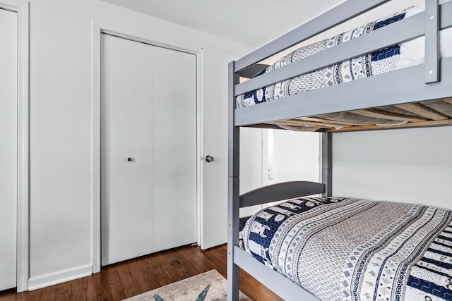 bedroom featuring dark wood-type flooring and a closet