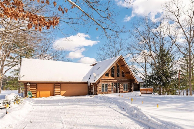 log cabin featuring a garage