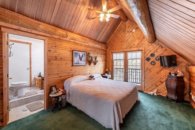 carpeted bedroom featuring french doors, ensuite bathroom, wood walls, lofted ceiling with beams, and access to exterior