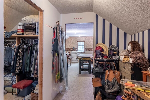 walk in closet with lofted ceiling and carpet floors