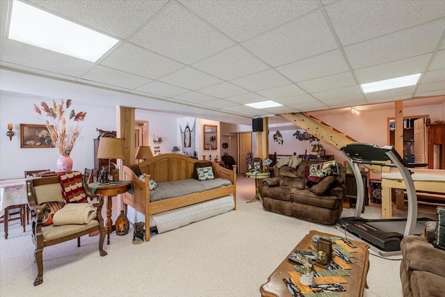 carpeted living room with a paneled ceiling