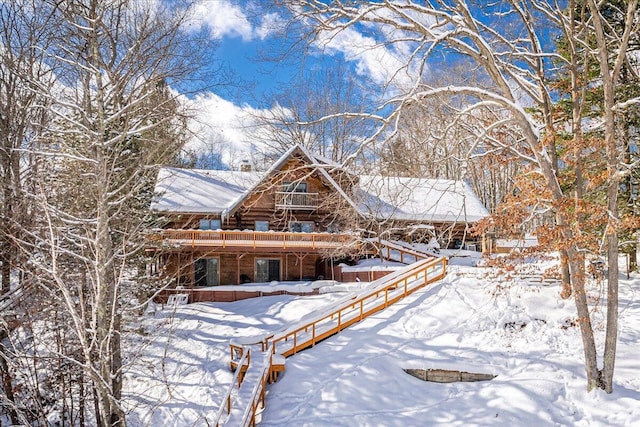 view of snow covered back of property