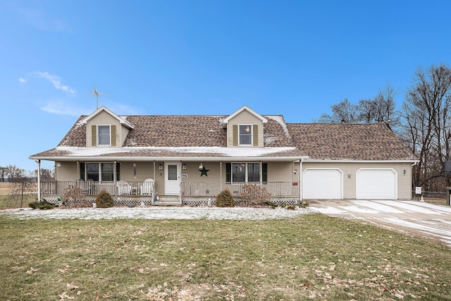 view of front of home with a garage, a front yard, and a porch