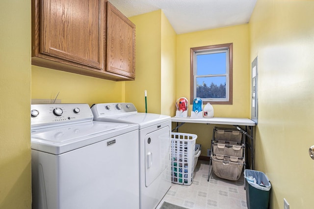 laundry area featuring cabinets and washing machine and clothes dryer