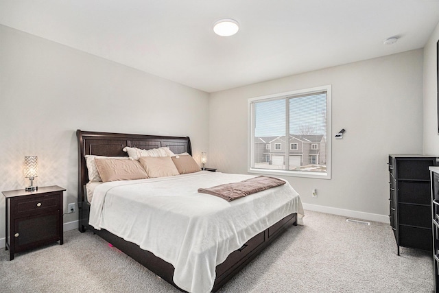 bedroom featuring light carpet