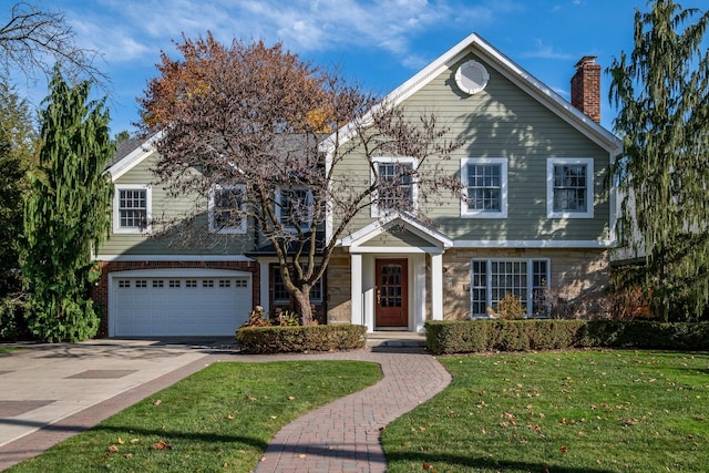 view of front of property featuring a garage and a front lawn