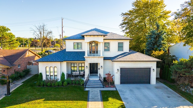 view of front facade featuring a porch, a garage, and a front lawn