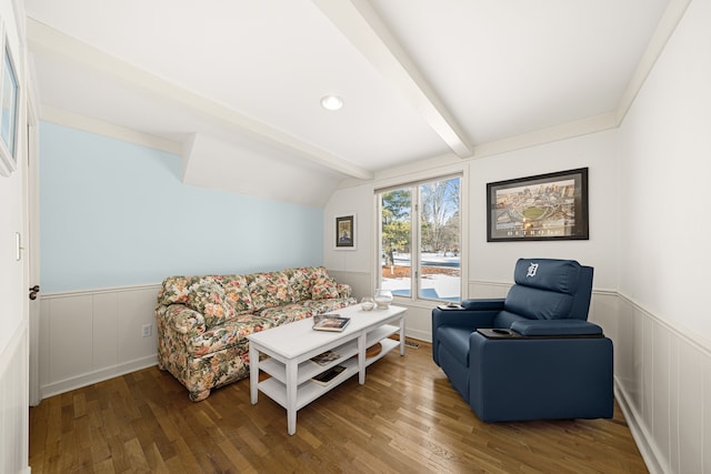 living room with hardwood / wood-style floors and vaulted ceiling with beams