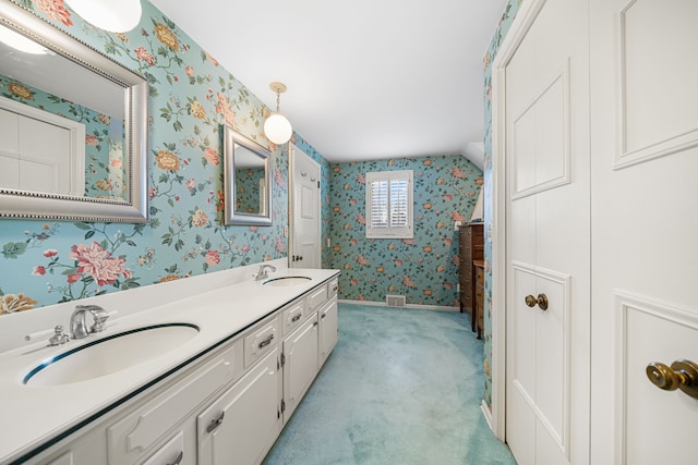 bathroom with vanity and vaulted ceiling