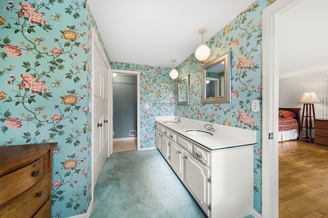 bathroom with hardwood / wood-style flooring and vanity