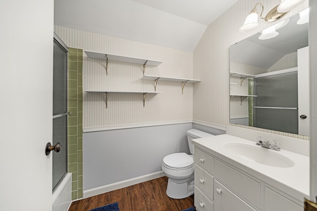 full bathroom featuring toilet, vaulted ceiling, vanity, hardwood / wood-style floors, and shower / bath combination with glass door