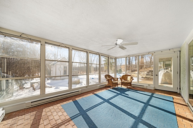 unfurnished sunroom with ceiling fan and baseboard heating