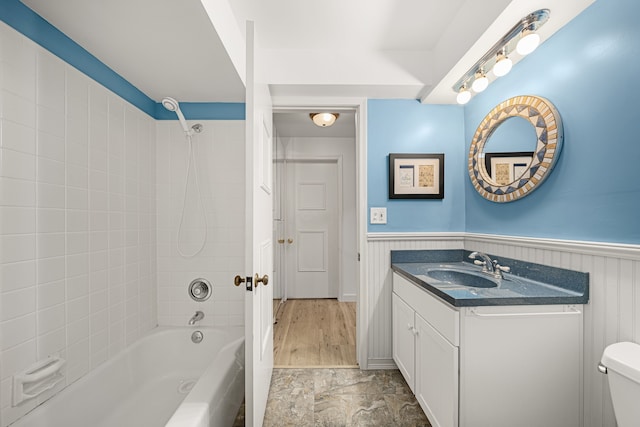 full bathroom with toilet, vanity, and tiled shower / bath