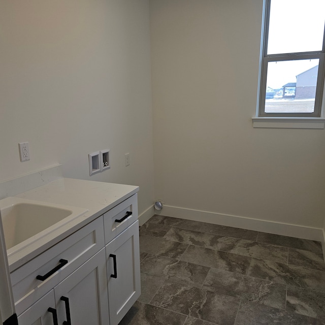 laundry area with cabinets, sink, and hookup for a washing machine