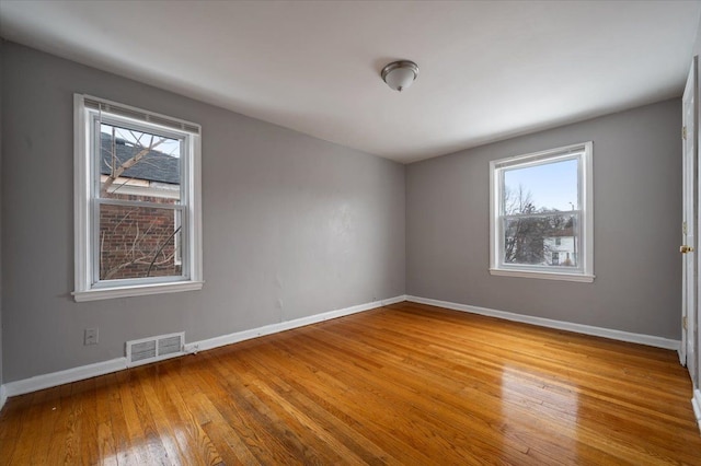 empty room featuring light hardwood / wood-style flooring and a healthy amount of sunlight