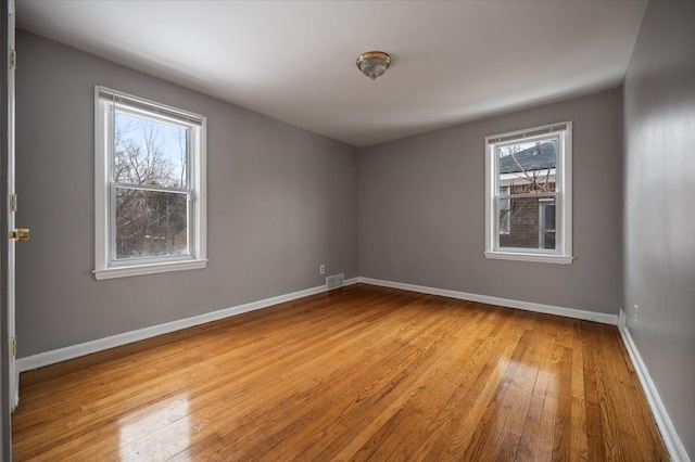 spare room with light wood-type flooring