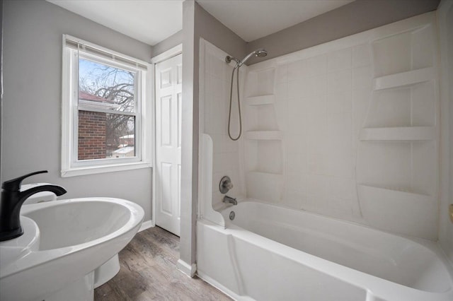 bathroom featuring wood-type flooring and shower / bath combination