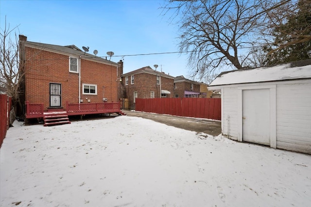 snow covered property featuring a shed