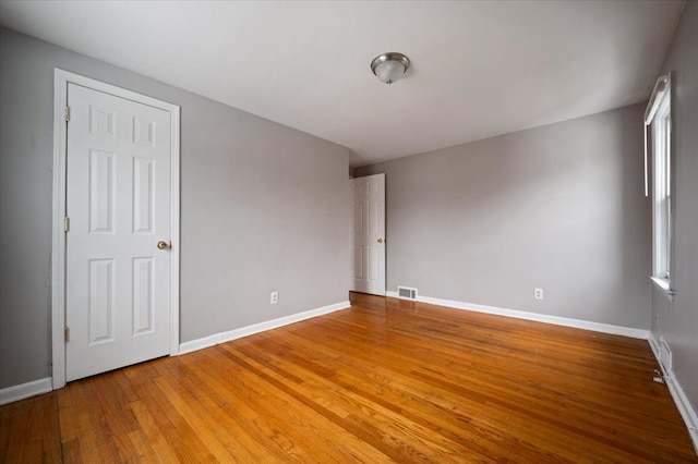 unfurnished room with hardwood / wood-style floors