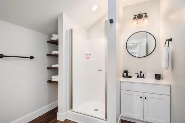 bathroom featuring vanity, hardwood / wood-style floors, and walk in shower