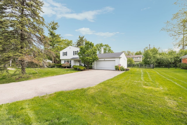 view of front of property with a garage and a front lawn