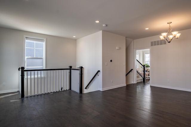 spare room with dark wood-style floors, baseboards, visible vents, and recessed lighting