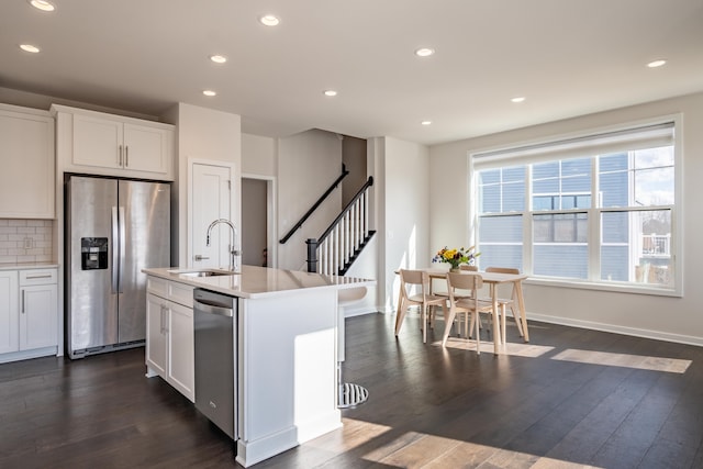 kitchen with dark wood-style floors, appliances with stainless steel finishes, a sink, and recessed lighting