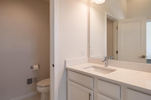 bathroom with baseboards, visible vents, toilet, tile patterned floors, and vanity