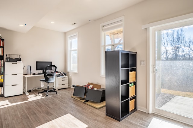 office space featuring baseboards, visible vents, wood finished floors, and recessed lighting