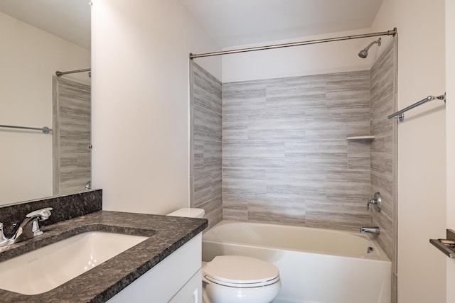 bathroom featuring washtub / shower combination, vanity, and toilet