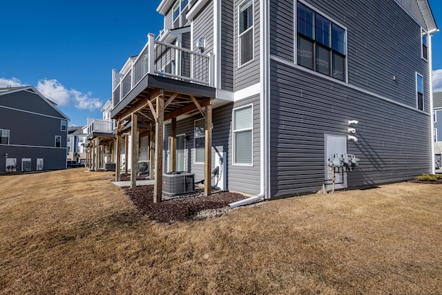 view of property exterior featuring a residential view, a lawn, and central AC unit