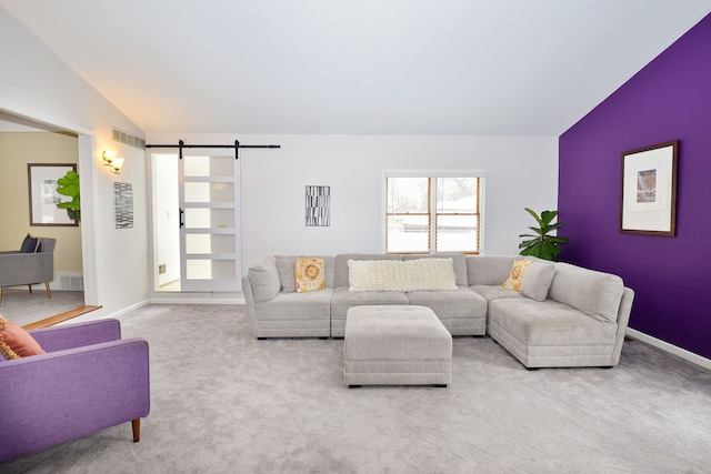 living room featuring a barn door, light colored carpet, and lofted ceiling