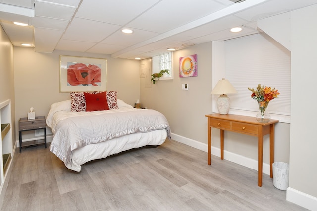 bedroom featuring a paneled ceiling and hardwood / wood-style flooring