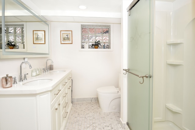 bathroom featuring vanity, toilet, and walk in shower