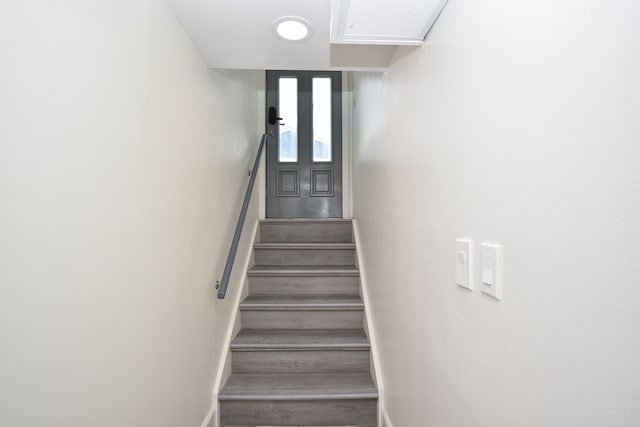 stairway featuring wood-type flooring