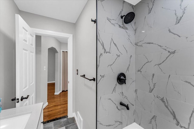 bathroom featuring vanity and tiled shower