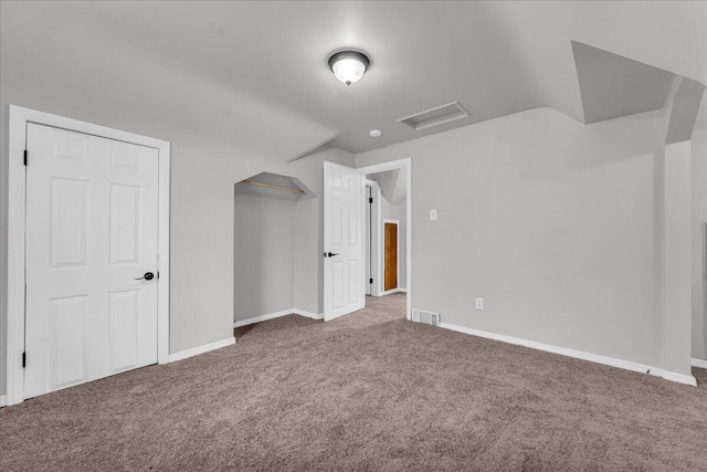 bonus room featuring dark carpet