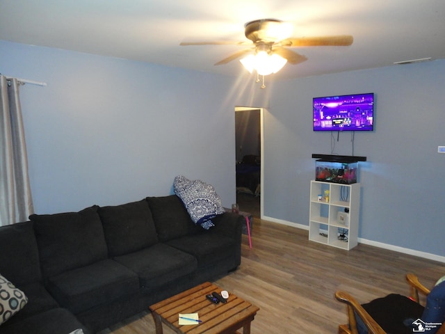 living room featuring wood-type flooring and ceiling fan