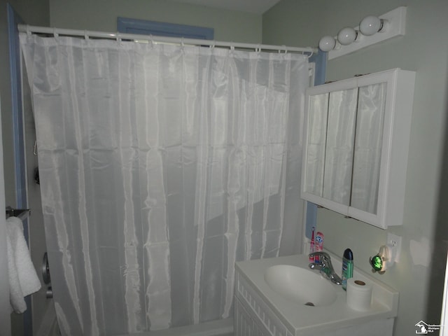 bathroom with sink and curtained shower