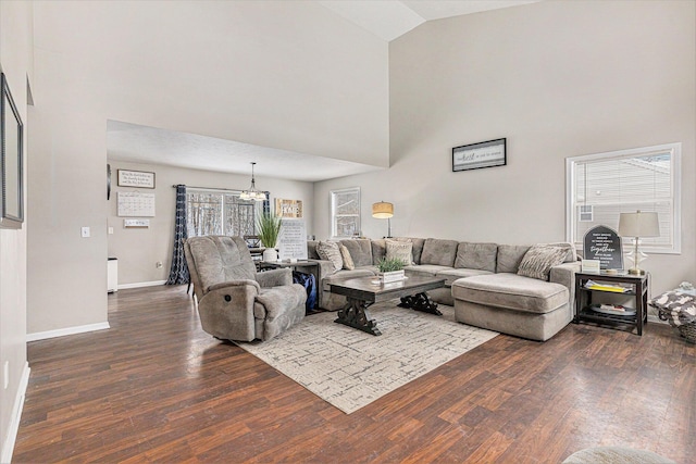 living room featuring high vaulted ceiling, a chandelier, and hardwood / wood-style floors