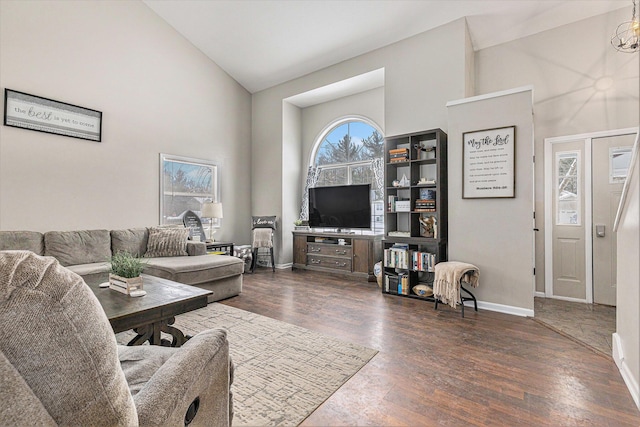 living room featuring dark hardwood / wood-style flooring and high vaulted ceiling