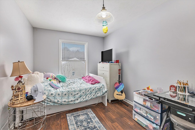 bedroom featuring dark wood-type flooring and a textured ceiling