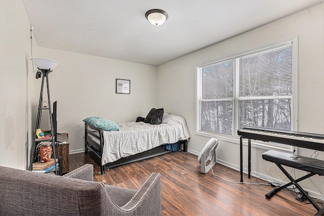 bedroom featuring dark hardwood / wood-style flooring and multiple windows