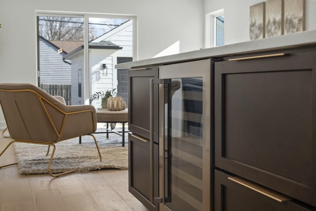 kitchen with beverage cooler and light hardwood / wood-style flooring