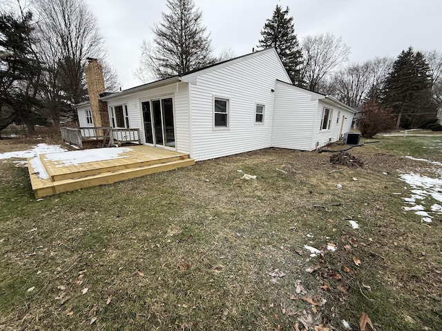 back of house featuring a wooden deck, central AC, and a lawn