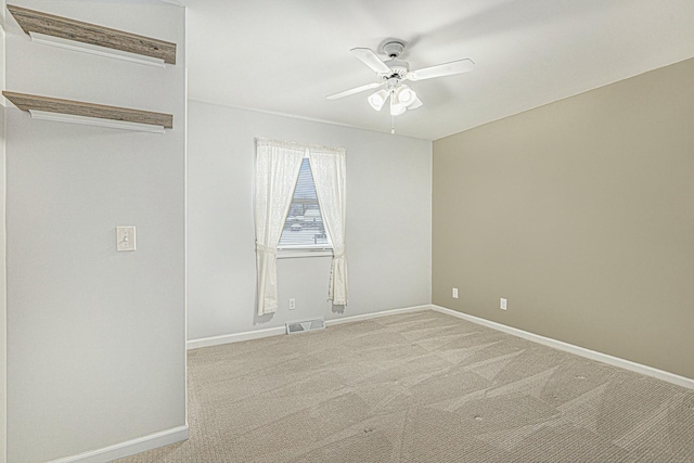 spare room with light carpet and ceiling fan